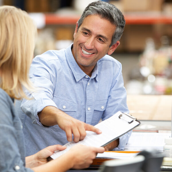 two coworkers looking over some paperwork