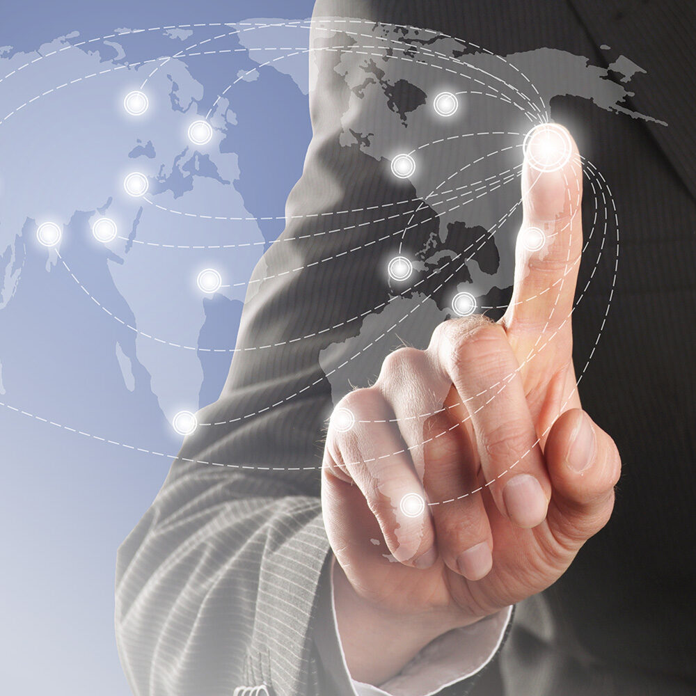 man pressing finger against world map